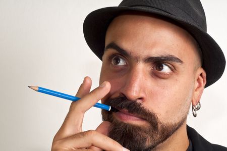 man with a pencil and a hat with funny expression with white backgroundの写真素材