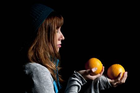 girl with orange and hat with black backgroundの写真素材