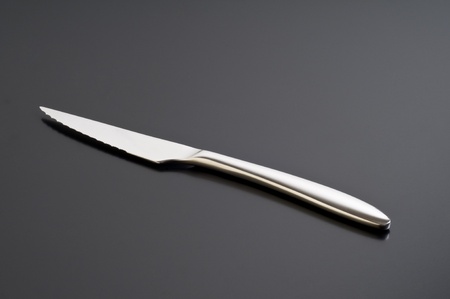 silver knife on a black table