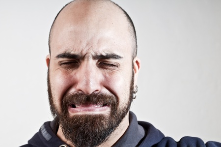 bearded man who cries on white background