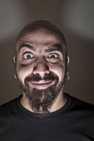 man with stupid face and dark lightの写真素材