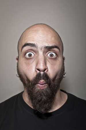 man with stupid face and dark lightの写真素材
