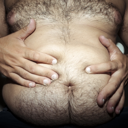 belly fat and hairy man with handsの写真素材