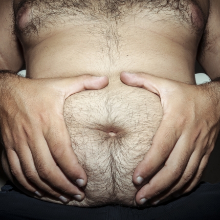 belly fat and hairy man with handsの写真素材