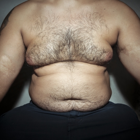 belly fat and hairy man with handsの写真素材