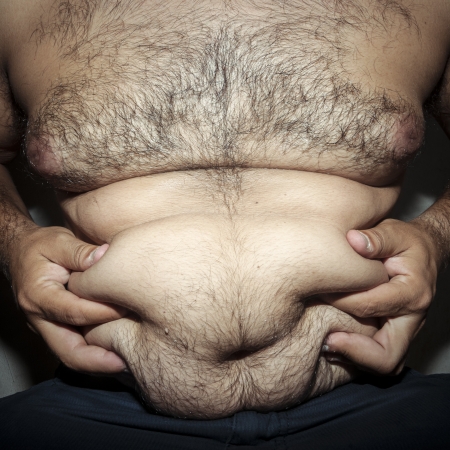 belly fat and hairy man with handsの写真素材