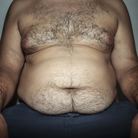 belly fat and hairy man with handsの写真素材