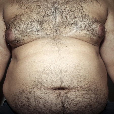 belly fat and hairy man with handsの写真素材