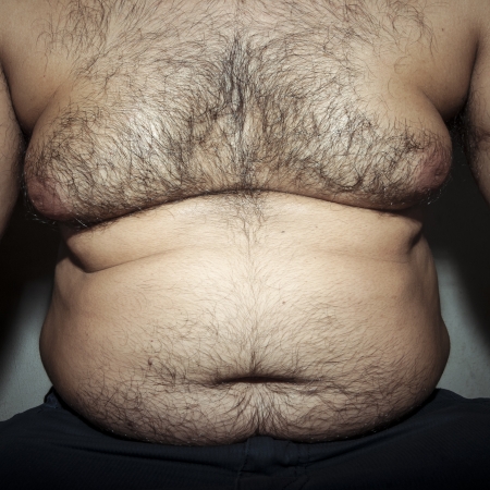belly fat and hairy man with handsの写真素材
