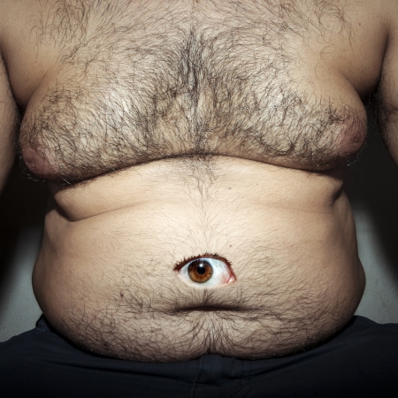 monstrous belly fat of dirty man with eyeの写真素材