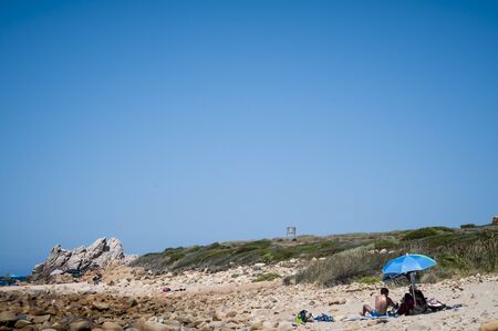 beach umbrella and towel on the sand in summertimeのeditorial素材