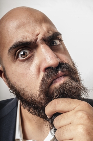 man with a suit and beard and strange expressions on white backgroundの写真素材