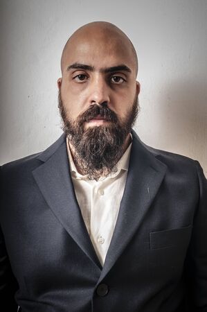 elegant bearded man with jacket and funny expressions on white backgroundの写真素材