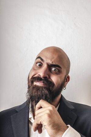 elegant bearded man with jacket and funny expressions on white backgroundの写真素材