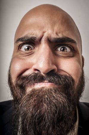 elegant bearded man with jacket and funny expressions on white backgroundの写真素材