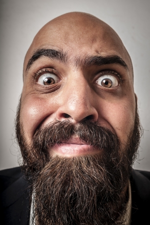 elegant bearded man with jacket and funny expressions on white backgroundの写真素材