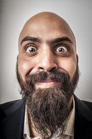 elegant bearded man with jacket and funny expressions on white backgroundの写真素材
