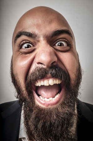 elegant bearded man with jacket and funny expressions on white backgroundの写真素材