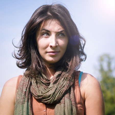 beautiful girl with scarf on the lawn in autumnの写真素材