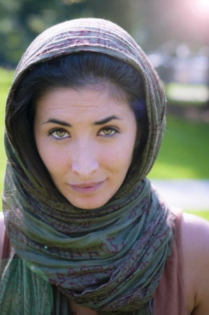 beautiful girl with scarf safi on the lawn in autumnの写真素材