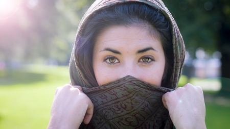 beautiful girl with scarf safi on the lawn in autumnの写真素材