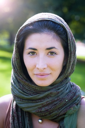 beautiful girl with scarf safi on the lawn in autumnの写真素材