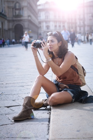 beautiful girl with scarf and camera on the lawn in autumnの写真素材