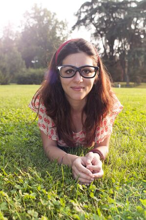 girl with big glasses and strange expressions at the parkの写真素材