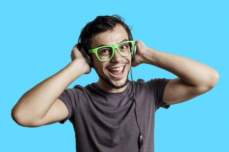 Crazy guy with headphones on blue backgroundの写真素材