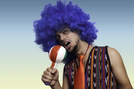 Crazy guy with blue wig on colorful backgroundの写真素材