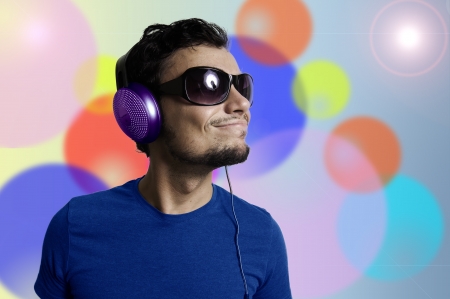 Crazy guy with headphones on colorful backgroundの写真素材