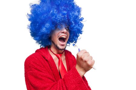 crazy guy with a toothbrush, wig and bathrobe singing on white backgroundの写真素材