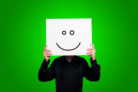 optimist person with sign and black shirt on green backgroundの写真素材