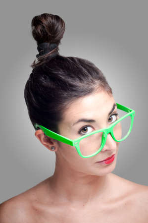 beautiful girl with green eyeglasses on gray backgroundの写真素材