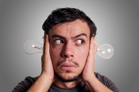 thinking guy with bulbs on grey backgroundの写真素材