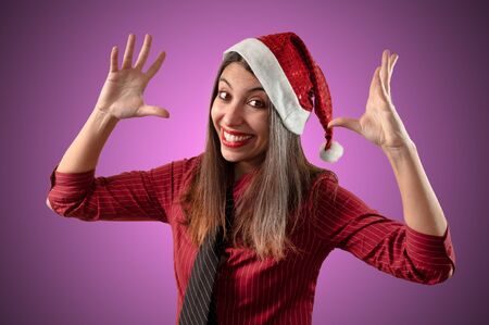 smiling business christmas girl on pink backgroundの写真素材