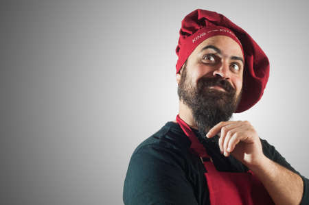 happy bearded chubby chef on grey backgroundの写真素材