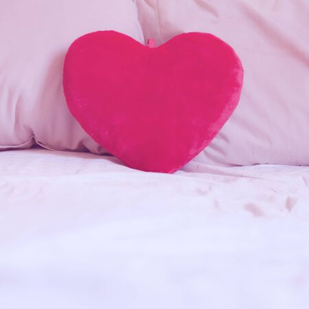 heart pillow on the bed for valentine dayの写真素材