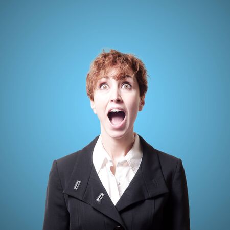 screaming success short hair business woman on blue backgroundの写真素材