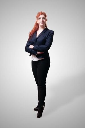 Success business woman with long red hair on white backgroundの写真素材