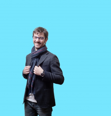 smiling casual business man with eyeglasses on blue backgroundの写真素材