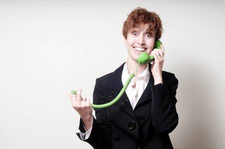 success short hair business woman using green phone handset on white backgroundの写真素材