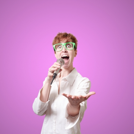 funny short hair singing on pink backgroundの写真素材