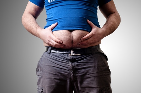 belly fat man on gray backgroundの写真素材