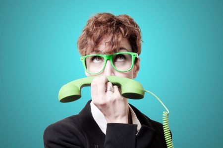 business woman with green phone handset like mustache on blue backgroundの写真素材