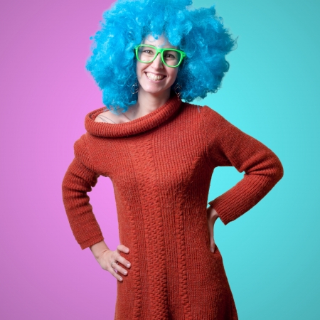 beautiful girl with curly blue wig and turtleneck on white backgroundの写真素材