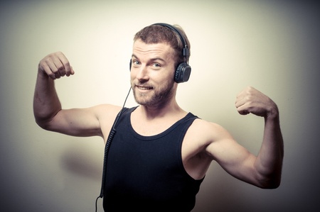 vintage portrait of fashion guy with headphones on gray background