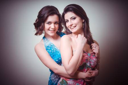 two beautiful girls on gray backgroundの写真素材