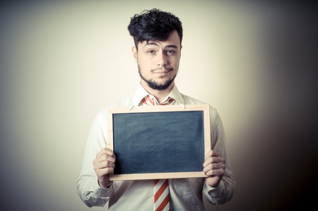businessman with a blank blackboard on gray background