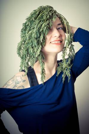 beautiful woman with carrots on hair on gray backgroundの写真素材
